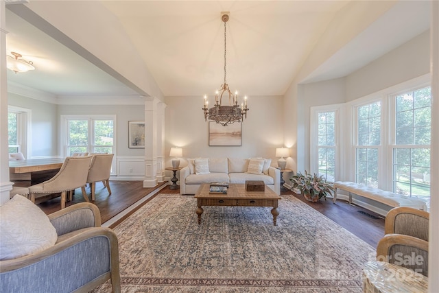 2836 Providence Spring Ln, Charlotte, NC 28270 - living room with wood finished floors, a chandelier, lofted ceiling, wainscoting, and ornamental molding