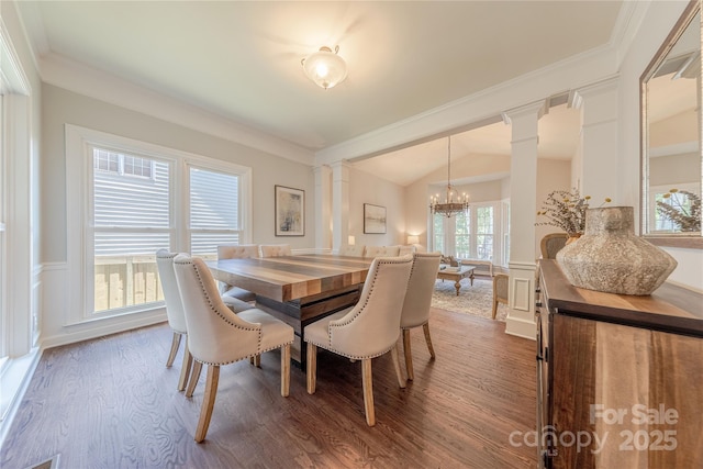 2836 Providence Spring Ln, Charlotte, NC 28270 - dining space with ornate columns, wood finished floors, a chandelier, ornamental molding, and wainscoting