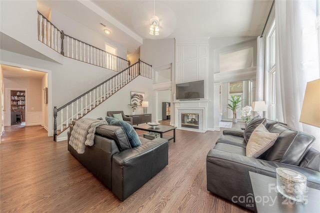 2836 Providence Spring Ln, Charlotte, NC 28270 - living area with high vaulted ceiling, stairs, wood finished floors, and a large fireplace