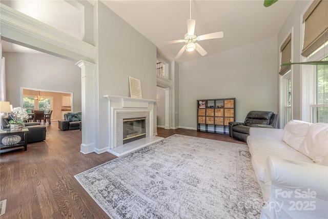 2836 Providence Spring Ln, Charlotte, NC 28270 - living area with a high ceiling, wood finished floors, ceiling fan, a high end fireplace, and a chandelier