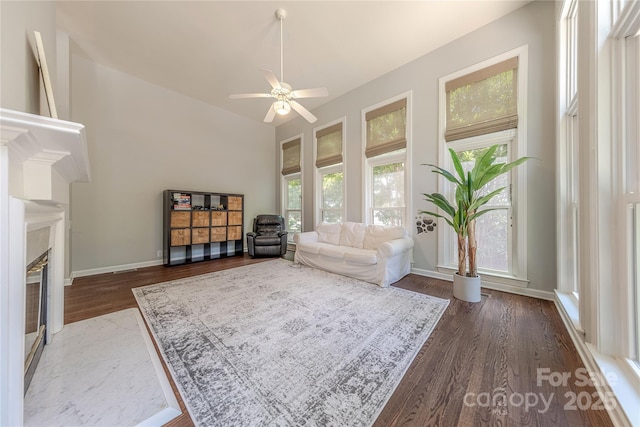 2836 Providence Spring Ln, Charlotte, NC 28270 - living room featuring dark wood-type flooring, ceiling fan, and a glass covered fireplace