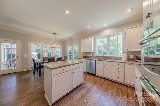 2836 Providence Spring Ln, Charlotte, NC 28270 - kitchen with appliances with stainless steel finishes, healthy amount of natural light, tasteful backsplash, wood finished floors, and ornamental molding