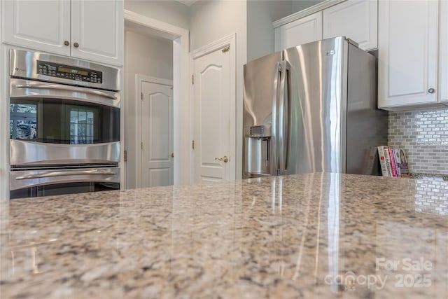 2836 Providence Spring Ln, Charlotte, NC 28270 - kitchen with stainless steel appliances, decorative backsplash, and white cabinets