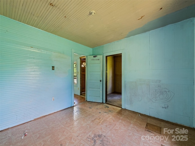 55 Shook St, Clyde, NC 28721 - unfurnished bedroom featuring light floors and wooden walls