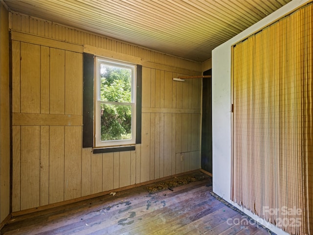 55 Shook St, Clyde, NC 28721 - unfurnished bedroom with wood-type flooring, wooden walls, and a closet