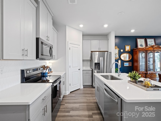 4170 County Down Ave, Kannapolis, NC 28081 - kitchen with appliances with stainless steel finishes, backsplash, light countertops, wood finished floors, and recessed lighting