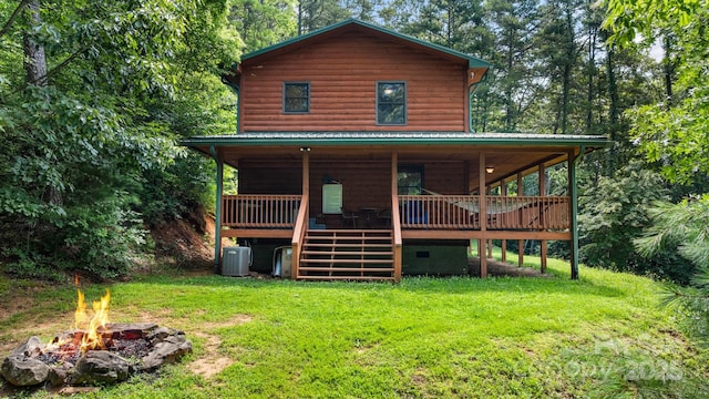 55 Kirkland Mountain Ln, Bryson City, NC 28713 - view of front of house with a front lawn, a fire pit, faux log siding, stairs, and a metal roof
