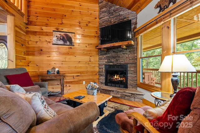 55 Kirkland Mountain Ln, Bryson City, NC 28713 - living room featuring wood finished floors, a fireplace, high vaulted ceiling, and wooden walls