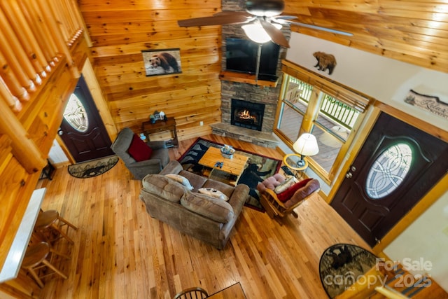 55 Kirkland Mountain Ln, Bryson City, NC 28713 - living room with a fireplace, hardwood / wood-style floors, ceiling fan, and wood walls
