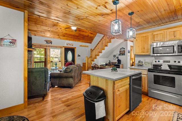 55 Kirkland Mountain Ln, Bryson City, NC 28713 - kitchen featuring appliances with stainless steel finishes, open floor plan, light countertops, light wood-style flooring, and a center island