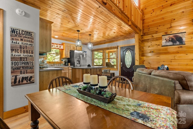 55 Kirkland Mountain Ln, Bryson City, NC 28713 - dining room featuring plenty of natural light, light wood-style flooring, and wood walls