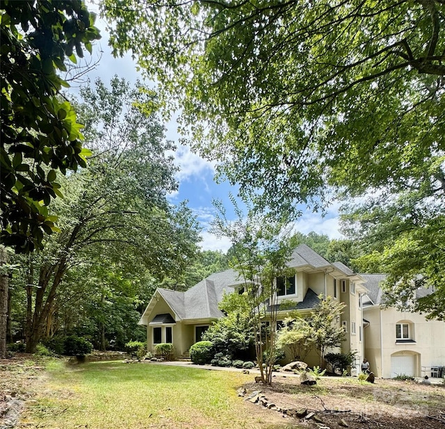 1802 Walden Pond Ln, Waxhaw, NC 28173 - view of property hidden behind natural elements featuring stucco siding, an attached garage, and a front yard