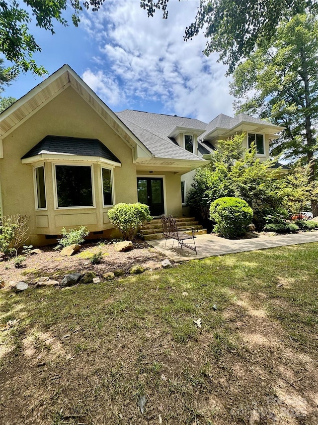 1802 Walden Pond Ln, Waxhaw, NC 28173 - back of property featuring roof with shingles, stucco siding, a patio area, and a lawn
