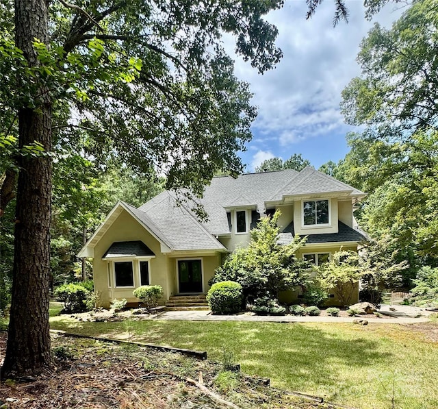 1802 Walden Pond Ln, Waxhaw, NC 28173 - view of front of home with a front yard, stucco siding, and roof with shingles