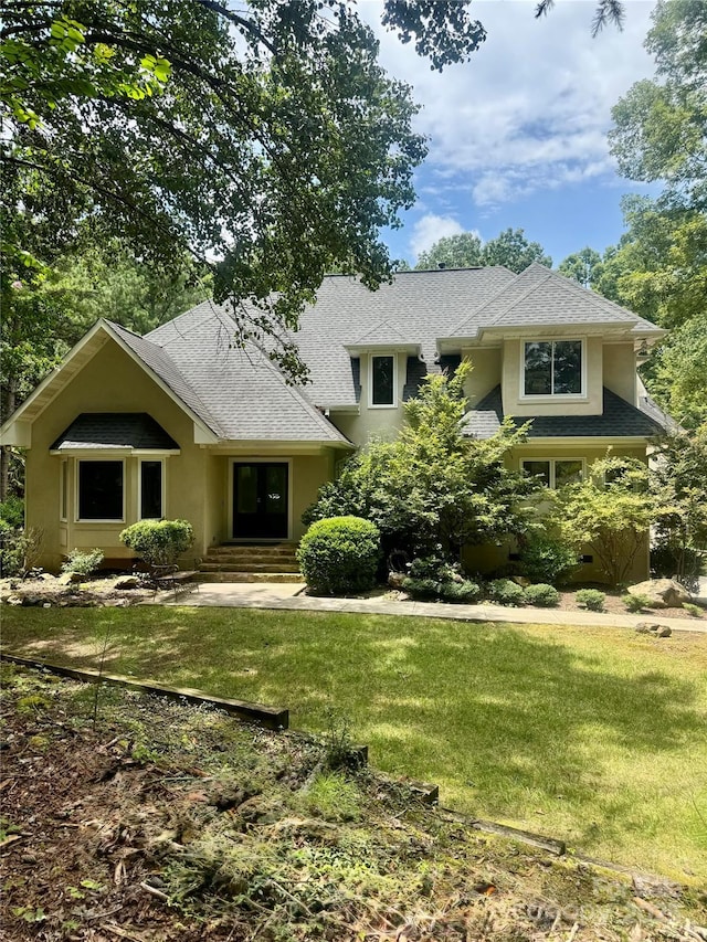 1802 Walden Pond Ln, Waxhaw, NC 28173 - view of front of property with a front yard, roof with shingles, and stucco siding