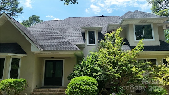 1802 Walden Pond Ln, Waxhaw, NC 28173 - property entrance with roof with shingles, french doors, and stucco siding