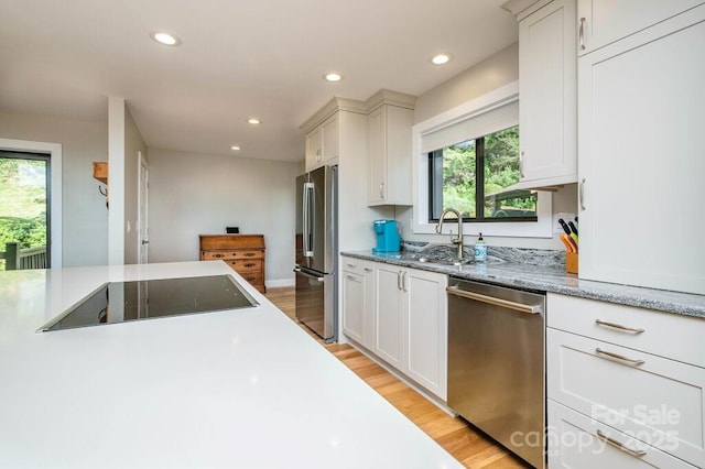 153 Country Ridge Rd, Laurel Park, NC 28739 - kitchen featuring stainless steel appliances, white cabinetry, recessed lighting, light wood-type flooring, and light stone counters