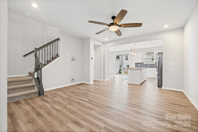 15626 Little Bluestem St, Charlotte, NC 28278 - unfurnished living room with ceiling fan, light wood-type flooring, stairs, and recessed lighting