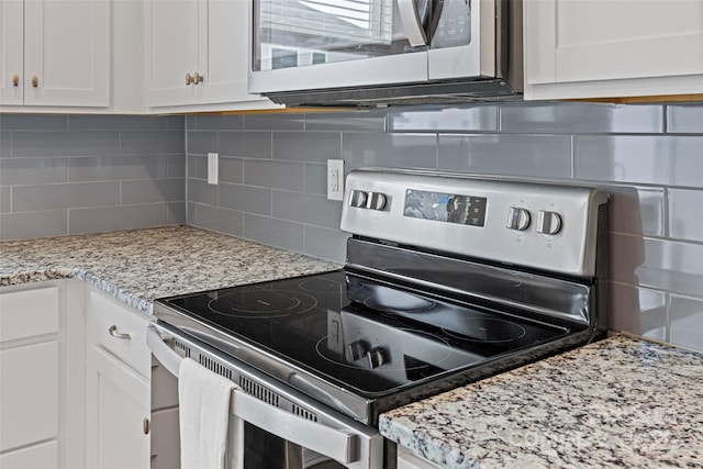 15626 Little Bluestem St, Charlotte, NC 28278 - kitchen with appliances with stainless steel finishes, decorative backsplash, white cabinetry, and light stone countertops