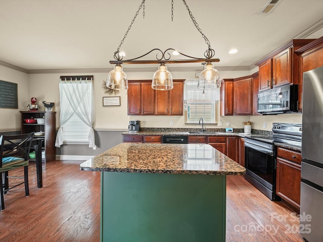 109 Dewfield Ln, Boiling Springs, SC 29316 - kitchen featuring stainless steel appliances, ornamental molding, a center island, dark stone countertops, and light wood-style flooring