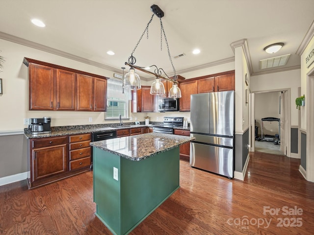 109 Dewfield Ln, Boiling Springs, SC 29316 - kitchen with stainless steel appliances, a kitchen island, dark stone countertops, dark wood-style floors, and crown molding