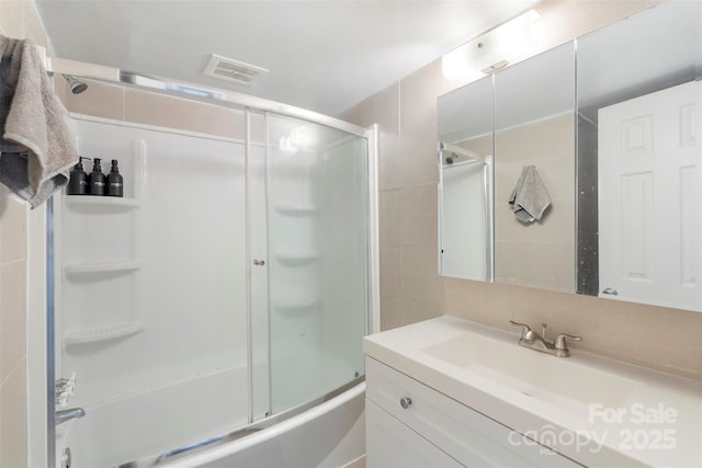 718 E Maple Ave, Gastonia, NC 28054 - full bath with vanity, bath / shower combo with glass door, and tile walls