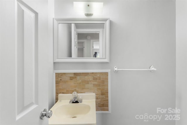 718 E Maple Ave, Gastonia, NC 28054 - bathroom with vanity and tasteful backsplash