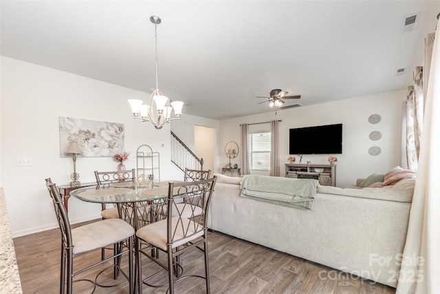 1111 Freeman View Dr, Albemarle, NC 28001 - dining space featuring a ceiling fan, wood finished floors, and a chandelier