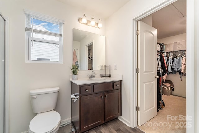 1111 Freeman View Dr, Albemarle, NC 28001 - bathroom featuring vanity, a spacious closet, and wood finished floors