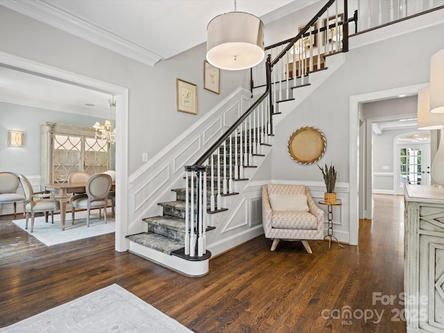 11624 Glenn Abbey Way, Charlotte, NC 28277 - stairway with a chandelier, wood finished floors, ornamental molding, a wainscoted wall, and a decorative wall