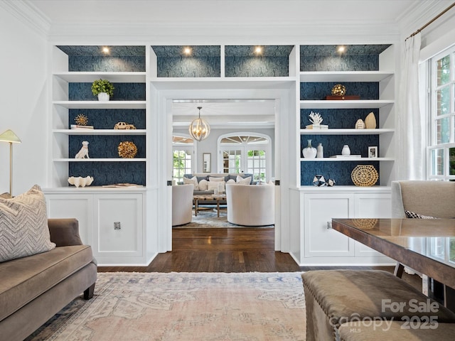 11624 Glenn Abbey Way, Charlotte, NC 28277 - living area with crown molding, built in shelves, plenty of natural light, dark wood-style floors, and a chandelier