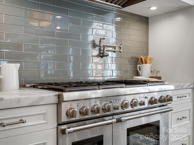 11624 Glenn Abbey Way, Charlotte, NC 28277 - kitchen featuring double oven range, tasteful backsplash, and white cabinetry