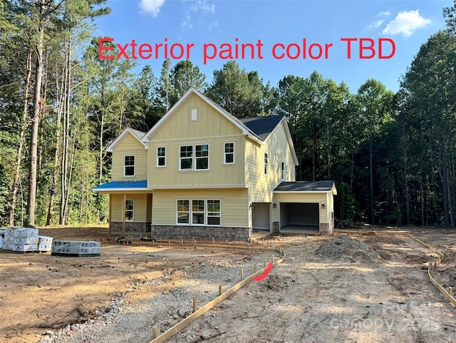 617 Autumnlight Dr, Salisbury, NC 28147 - view of front of house featuring stone siding, a garage, board and batten siding, and a wooded view