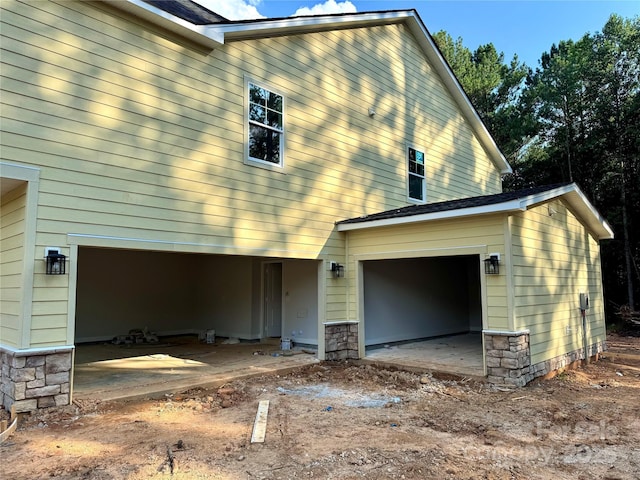 617 Autumnlight Dr, Salisbury, NC 28147 - view of side of property featuring stone siding and a garage