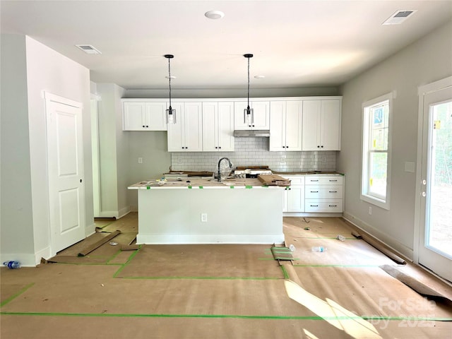 617 Autumnlight Dr, Salisbury, NC 28147 - kitchen featuring white cabinetry, tasteful backsplash, under cabinet range hood, and an island with sink