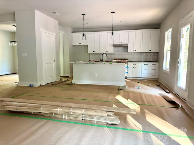 617 Autumnlight Dr, Salisbury, NC 28147 - kitchen featuring white range with gas cooktop, backsplash, white cabinets, and a center island with sink