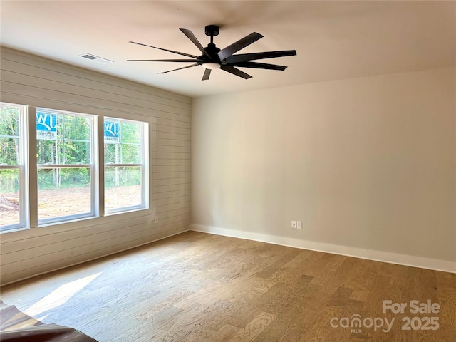 617 Autumnlight Dr, Salisbury, NC 28147 - spare room with wood finished floors, wooden walls, and ceiling fan