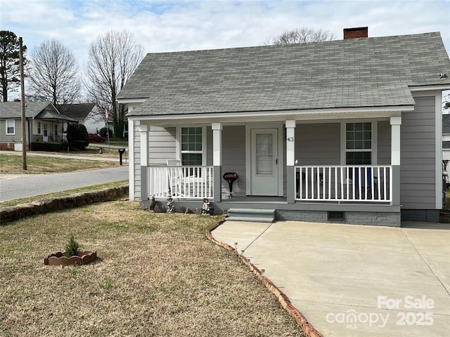 43 Mandalay Pl SW, Concord, NC 28027 - view of front of house with covered porch, roof with shingles, and a chimney