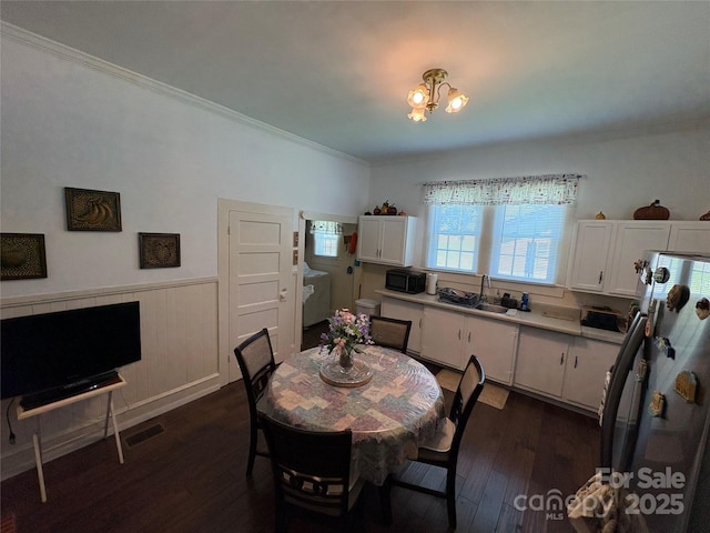 43 Mandalay Pl SW, Concord, NC 28027 - dining space with dark wood finished floors, wainscoting, ornamental molding, and a chandelier
