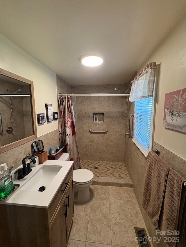 43 Mandalay Pl SW, Concord, NC 28027 - bathroom with tile walls, tiled shower, vanity, and tile patterned flooring