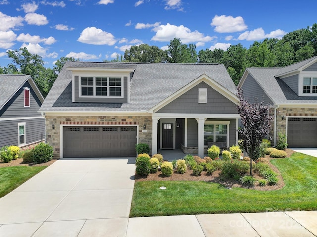 2019 Trailwood Dr, Matthews, NC 28104 - craftsman-style house with driveway, covered porch, a front lawn, and stone siding