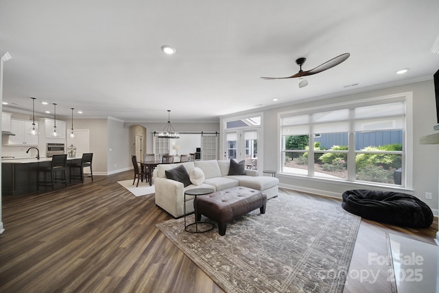 2019 Trailwood Dr, Matthews, NC 28104 - living room featuring ornamental molding, dark wood-style flooring, recessed lighting, ceiling fan, and a chandelier
