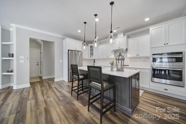 2019 Trailwood Dr, Matthews, NC 28104 - kitchen featuring appliances with stainless steel finishes, under cabinet range hood, light countertops, white cabinetry, and recessed lighting