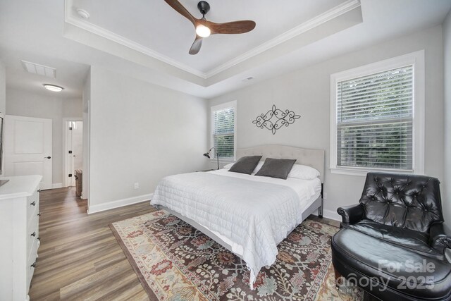 2019 Trailwood Dr, Matthews, NC 28104 - bedroom with a tray ceiling, wood finished floors, crown molding, and a ceiling fan