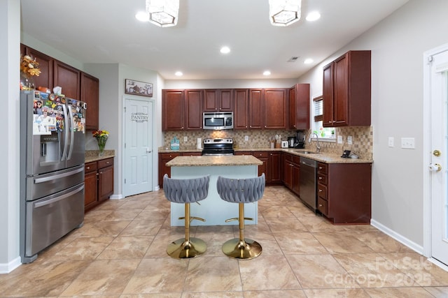 172 Roanoke Rd, Fletcher, NC 28732 - kitchen with appliances with stainless steel finishes, tasteful backsplash, a center island, light stone countertops, and a kitchen breakfast bar