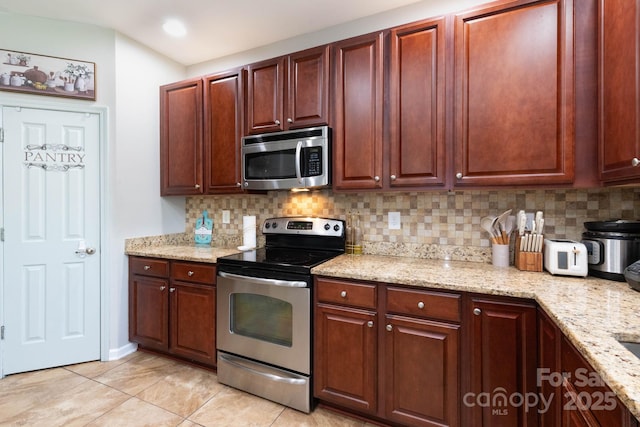 172 Roanoke Rd, Fletcher, NC 28732 - kitchen featuring stainless steel appliances, backsplash, light tile patterned floors, light stone counters, and recessed lighting