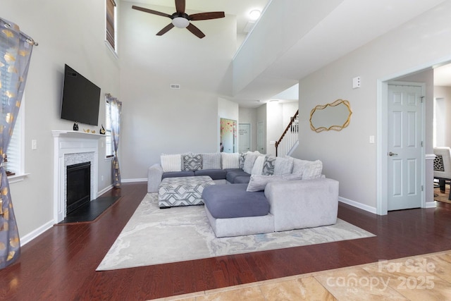 172 Roanoke Rd, Fletcher, NC 28732 - living area with ceiling fan, wood finished floors, a high end fireplace, stairway, and a towering ceiling