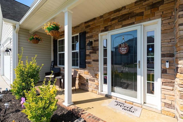 172 Roanoke Rd, Fletcher, NC 28732 - entrance to property featuring stone siding, a porch, and roof with shingles
