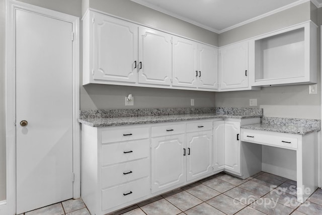 524 Bonview Ave, Lincolnton, NC 28092 - kitchen with white cabinetry, light tile patterned flooring, ornamental molding, light stone countertops, and built in study area