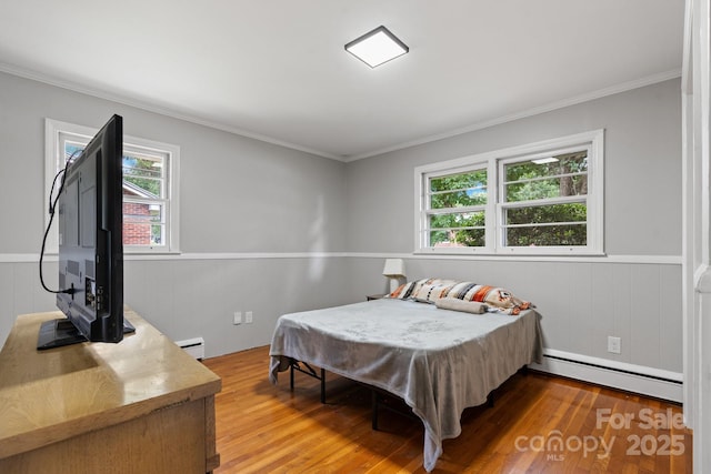 524 Bonview Ave, Lincolnton, NC 28092 - bedroom featuring baseboard heating, light wood-style flooring, ornamental molding, and a wainscoted wall